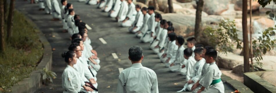 people in white uniform walking on road during daytime