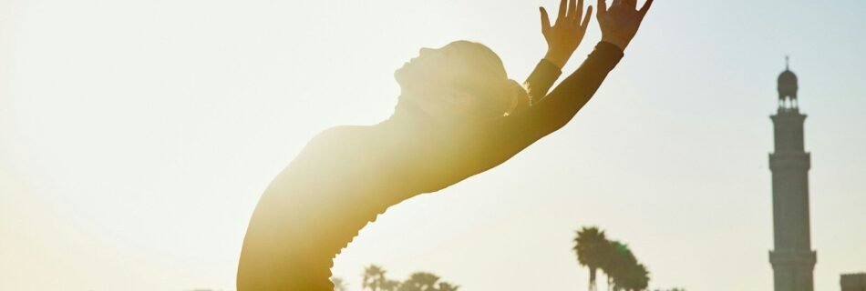 a person reaching up to catch a frisbee