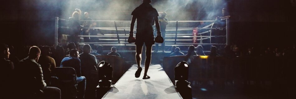 man standing and walking going on boxing ring surrounded with people