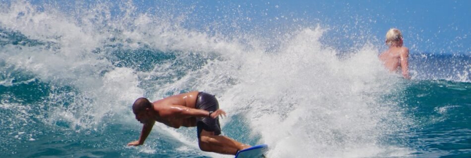 man surfing on sea waves during daytime