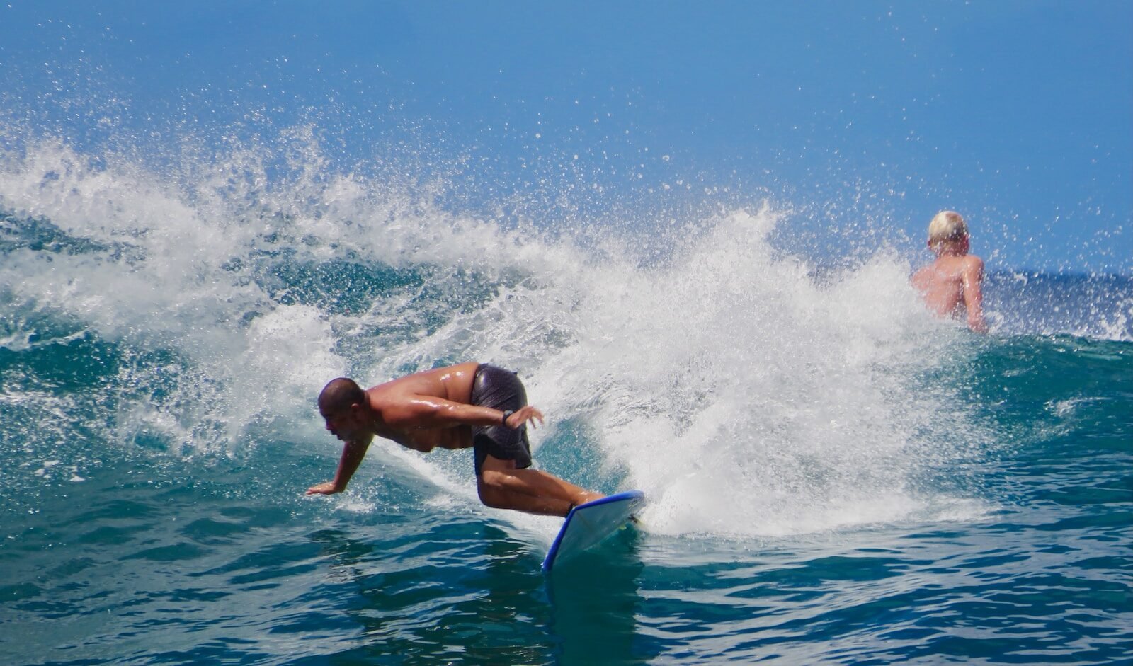 man surfing on sea waves during daytime